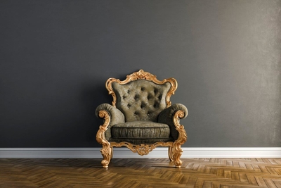 Ornate chair positioned against an aubergine background